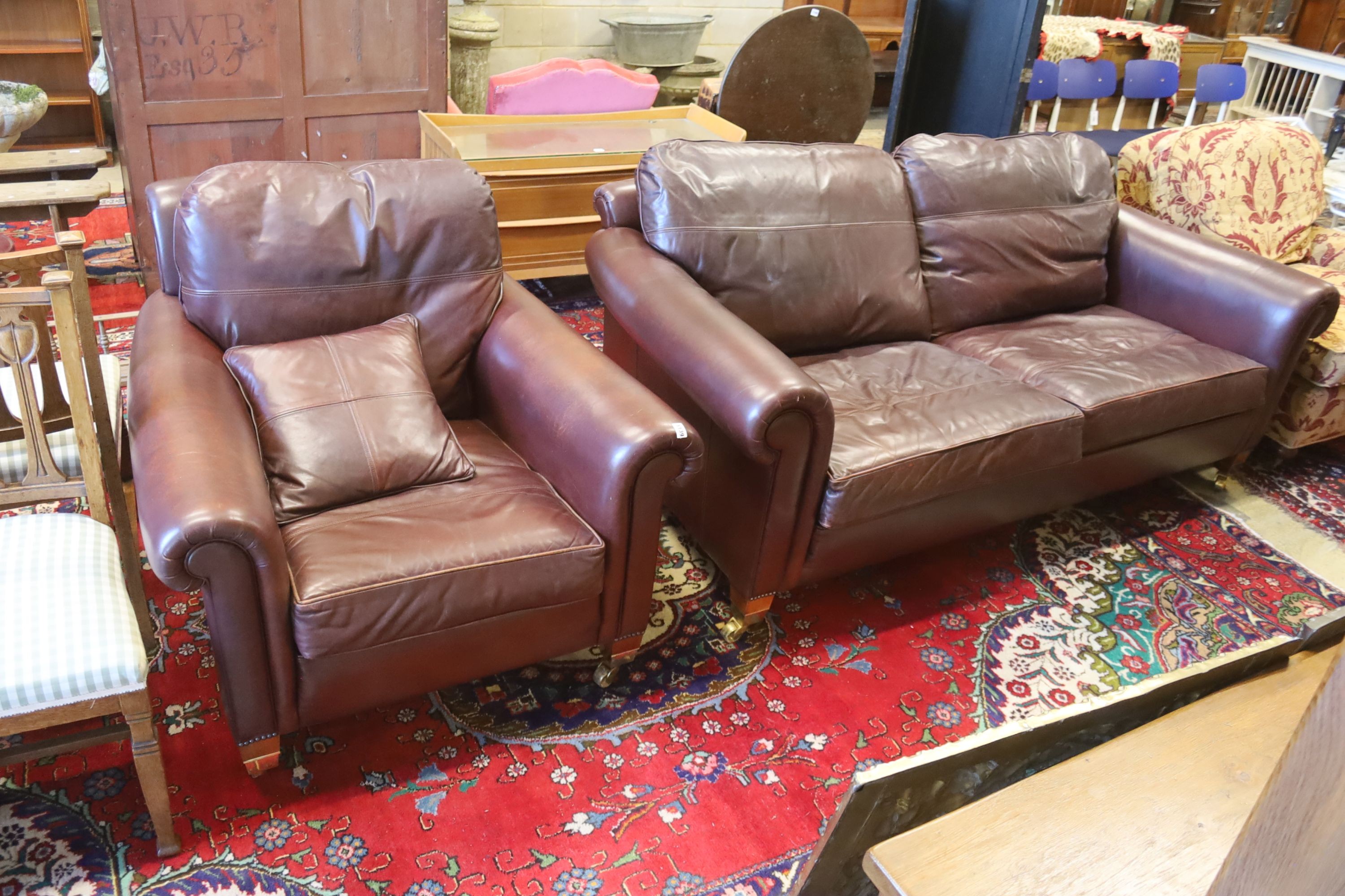 A Duresta brown leather settee and matching armchair, settee length 210cm, depth 102cm, height 90cm